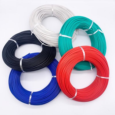 White insulated wire coil with a stripped conductor end.